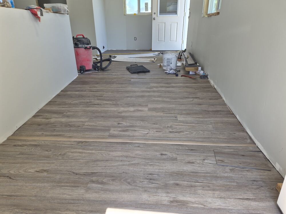 A finished hallway with new flooring throughout