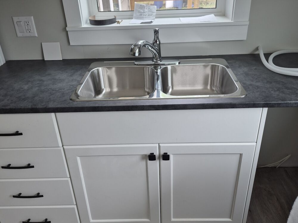 The finished kitchen with new cabinets, counter and sink