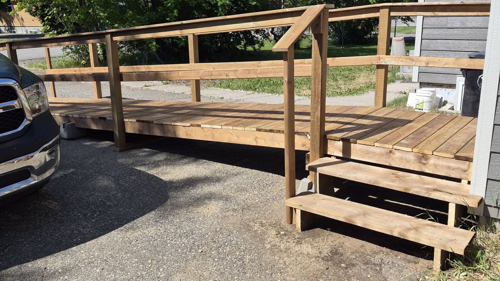 The newly built wheelchair ramp and deck leading to the duplex entrance